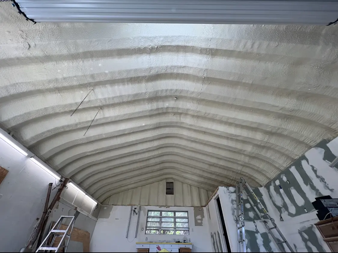 Spray polyurethane foam applied to the underside of a metal roof deck in Watertown
